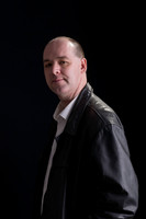 male "low key" "studio portrait" "black background"